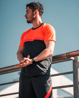 Trainer outdoors in red outfit